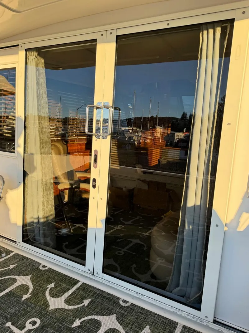 Slide: The Image of Navigator 5700 Rival 2002 yacht with glass sliding doors and nautical-themed carpet. - 8