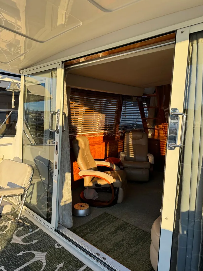 Slide: The Image of Interior view of 2002 Navigator 5700 Rival yacht with sliding glass doors and cozy seating. - 9