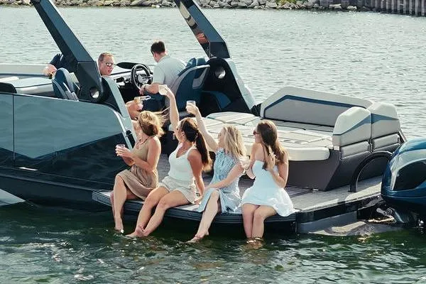 Slide: The Image of Group enjoying on a Custom rOve 225 boat, 2026 model, by the water. - 3