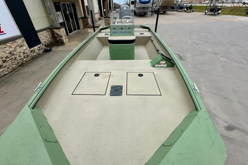 Slide: The Image of 2026 SeaArk Shadow 18 boat with spacious deck, green accents, and storage compartments. - 10