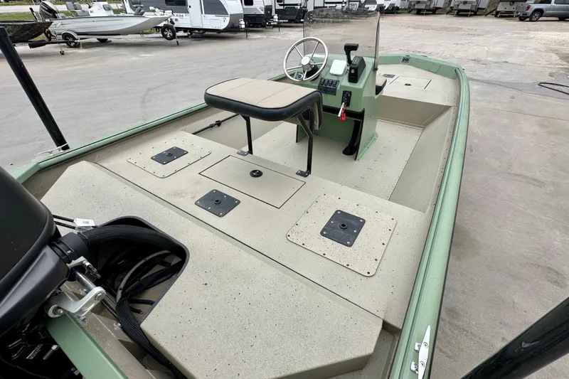 Slide: The Image of 2026 SeaArk Shadow 18 boat with spacious deck and steering console. - 12