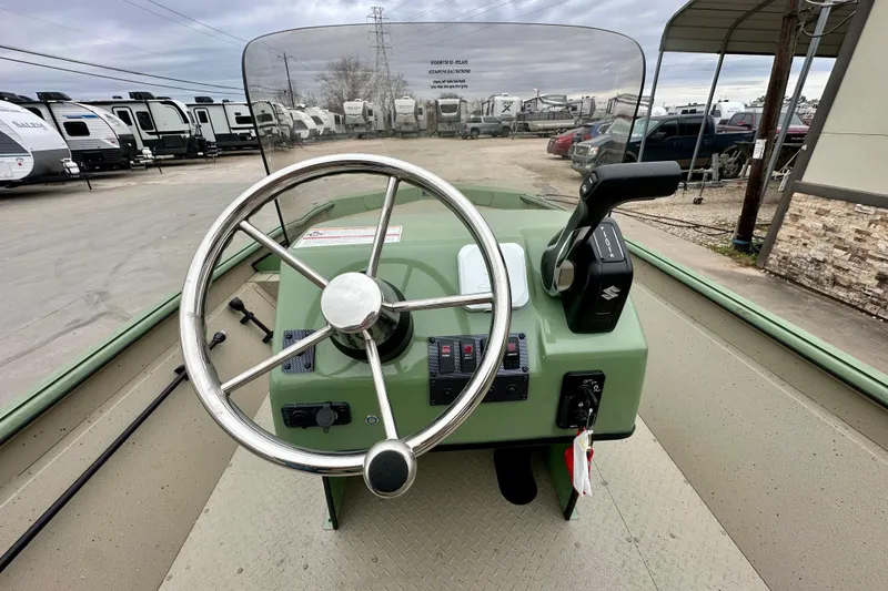 Slide: The Image of Steering console of 2026 SeaArk Shadow 18 boat, featuring a wheel and controls. - 14