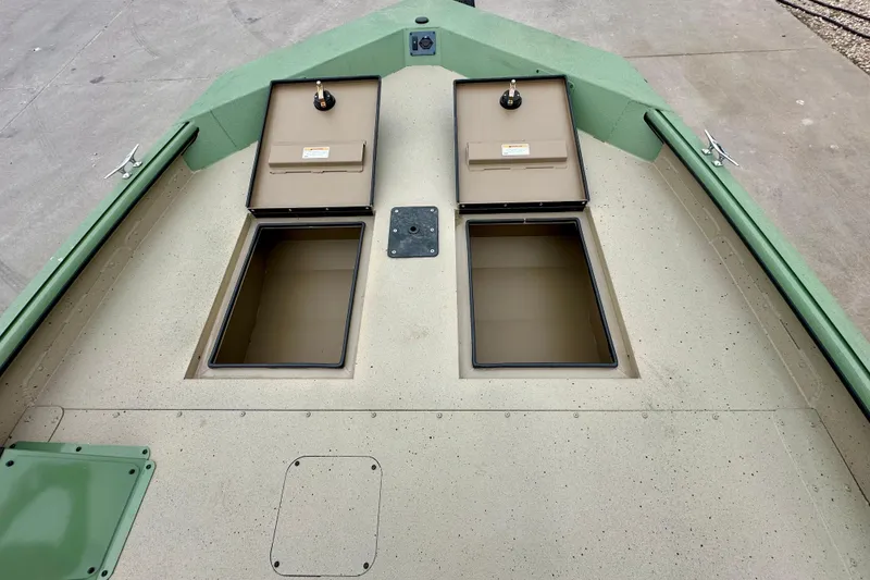 Slide: The Image of 2026 SeaArk Shadow 18 boat deck with open storage compartments. - 20