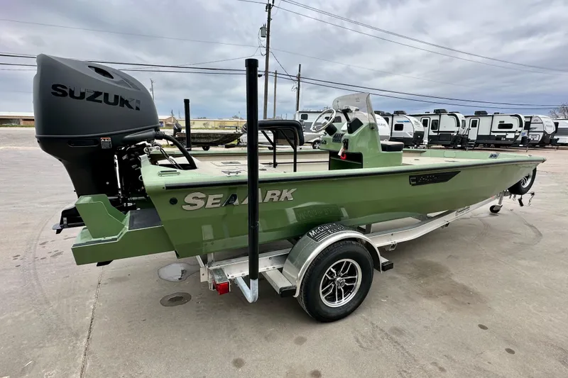 Slide: The Image of 2026 SeaArk Shadow 18 boat with Suzuki engine on trailer, parked outdoors. - 3