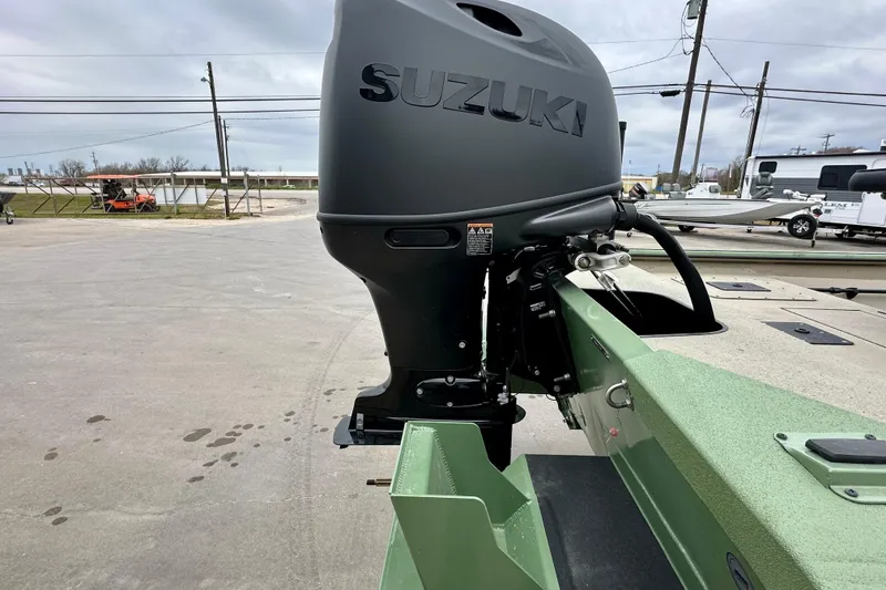 Slide: The Image of 2026 SeaArk Shadow 18 boat with Suzuki outboard motor in a parking lot. - 4