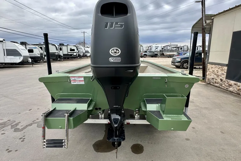 Slide: The Image of 2026 SeaArk Shadow 18 boat with powerful outboard motor, parked outdoors. - 5