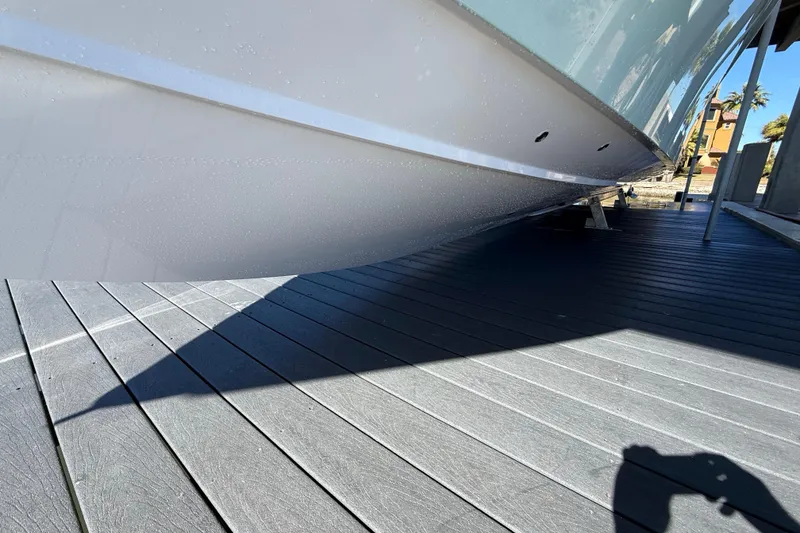 Slide: The Image of 2009 Venture 39 Open boat hull on a dock, showcasing sleek design and shadow. - 11