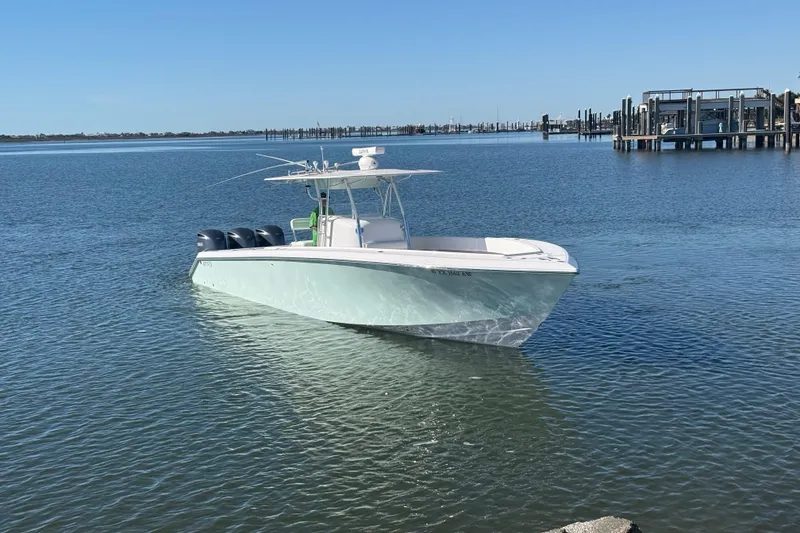 Slide: The Image of 2009 Venture 39 Open boat on calm water near a marina. - 3