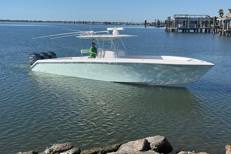 Slide: The Image of 2009 Venture 39 Open boat on calm water near a dock. - 4