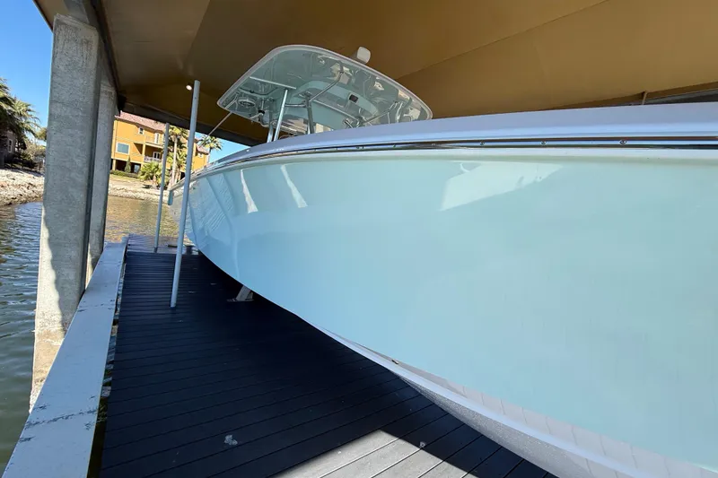 Slide: The Image of 2009 Venture 39 Open boat docked under a covered structure. - 9