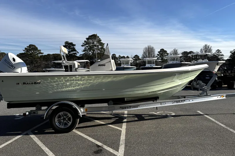 Slide: The Image of 2026 Bulls Bay 2000 boat on trailer, parked outdoors under clear sky. - 4