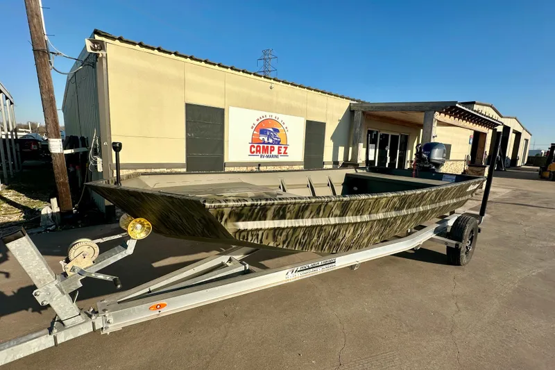 The Image of 2026 SeaArk 1652 Special boat on trailer outside Camp EZ building. - 1