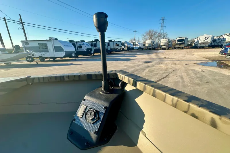 Slide: The Image of 2026 SeaArk 1652 Special boat interior with control panel, parked RVs in background. - 12