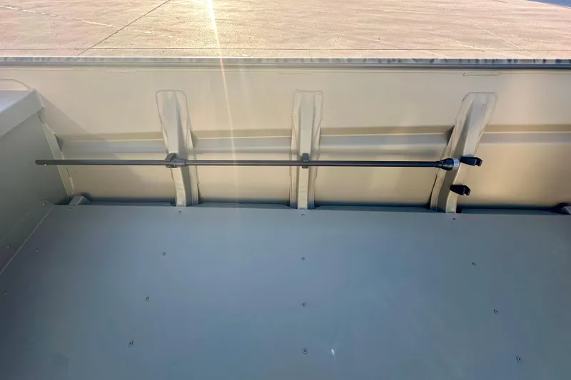 Slide: The Image of 2026 SeaArk 1652 Special boat interior with rod holder, sunlight streaming in. - 13