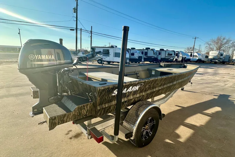 Slide: The Image of 2026 SeaArk 1652 Special boat with Yamaha motor on trailer, parked outdoors. - 4