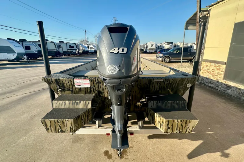 Slide: The Image of 2026 SeaArk 1652 Special boat with 40 HP motor, parked outdoors. - 5