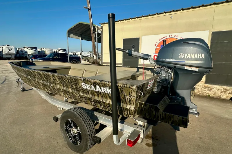 Slide: The Image of 2026 SeaArk 1652 Special boat with Yamaha motor on a trailer, parked outdoors. - 6