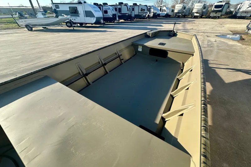 Slide: The Image of 2026 SeaArk 1652 Special boat, empty interior, parked near RVs and trailers. - 9