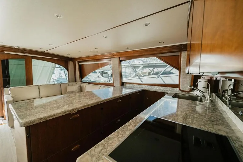 Slide: The Image of Luxurious interior of 2021 Viking 58 Convertible yacht with modern kitchen and seating area. - 100