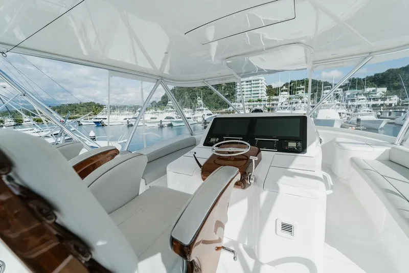 Slide: The Image of Luxurious 2021 Viking 58 Convertible yacht interior with modern helm and marina view. - 101