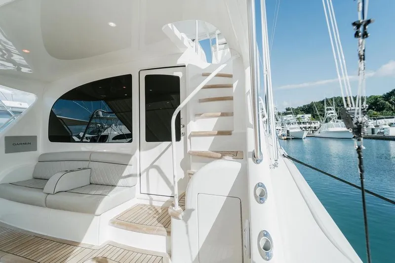 Slide: The Image of Luxurious 2021 Viking 58 Convertible yacht interior with seating and staircase, docked at marina. - 107