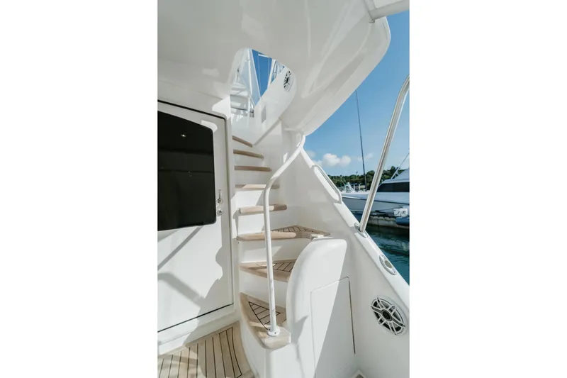 Slide: The Image of Staircase on 2021 Viking 58 Convertible yacht, featuring sleek design and ocean view. - 108