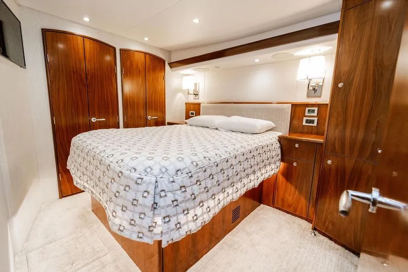 Slide: The Image of Luxurious bedroom interior of 2021 Viking 58 Convertible yacht with elegant wood finishes. - 11