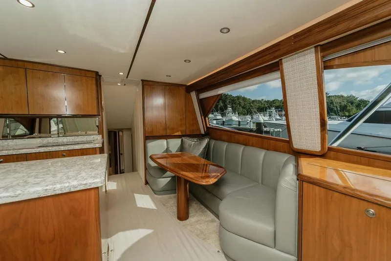 Slide: The Image of Luxurious interior of 2021 Viking 58 Convertible yacht with wood finishes and plush seating. - 110