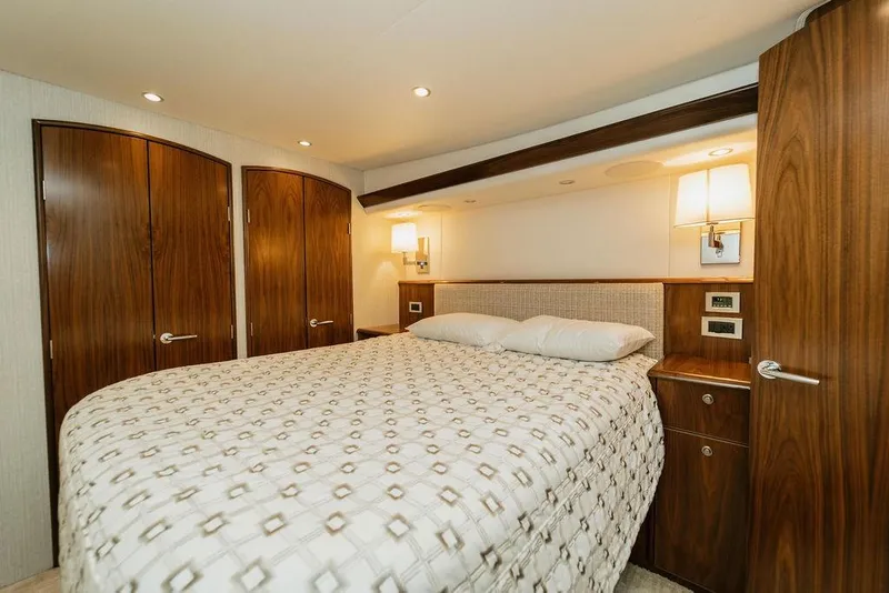 Slide: The Image of Luxurious bedroom interior of 2021 Viking 58 Convertible yacht with elegant wood finishes. - 111