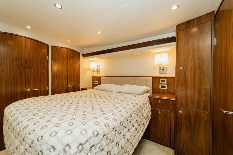 Slide: The Image of Luxurious bedroom interior of 2021 Viking 58 Convertible yacht with elegant wood finish. - 112
