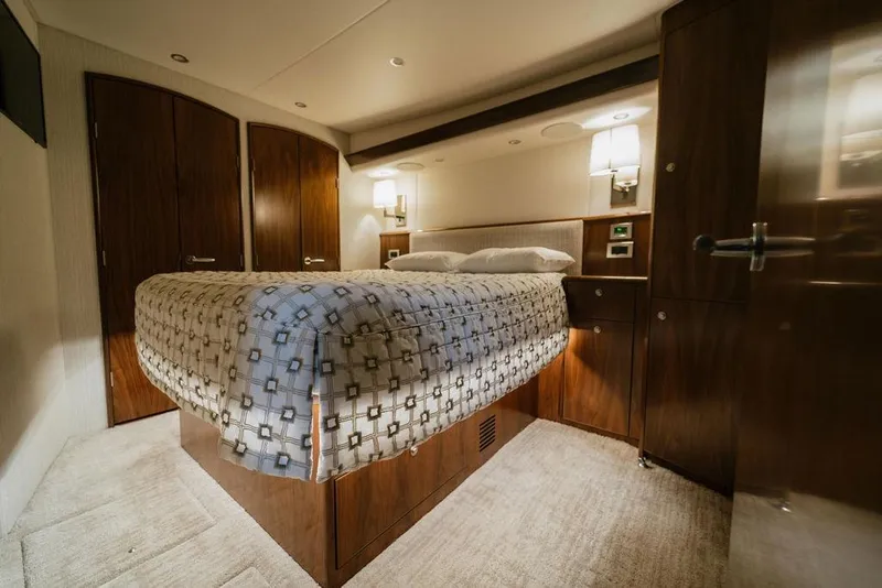 Slide: The Image of Luxurious bedroom interior of 2021 Viking 58 Convertible yacht with elegant wood finishes. - 113