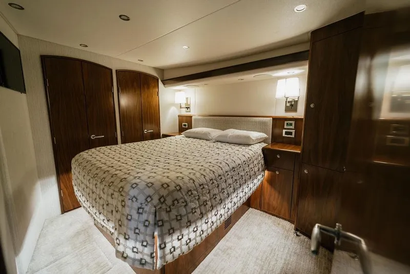 Slide: The Image of Luxurious bedroom interior of 2021 Viking 58 Convertible yacht with elegant wood finishes. - 114