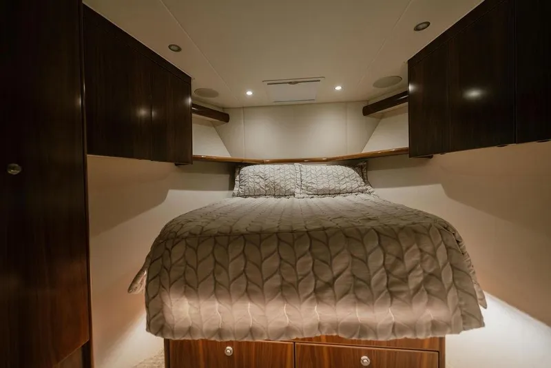 Slide: The Image of Luxurious cabin interior of 2021 Viking 58 Convertible yacht with cozy bed and wooden cabinets. - 116