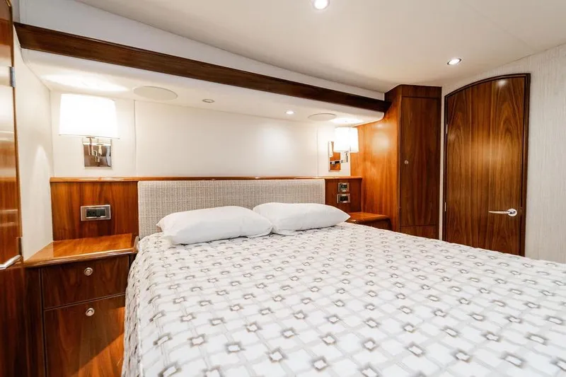 Slide: The Image of Luxurious cabin interior of 2021 Viking 58 Convertible yacht with elegant wood finish. - 12