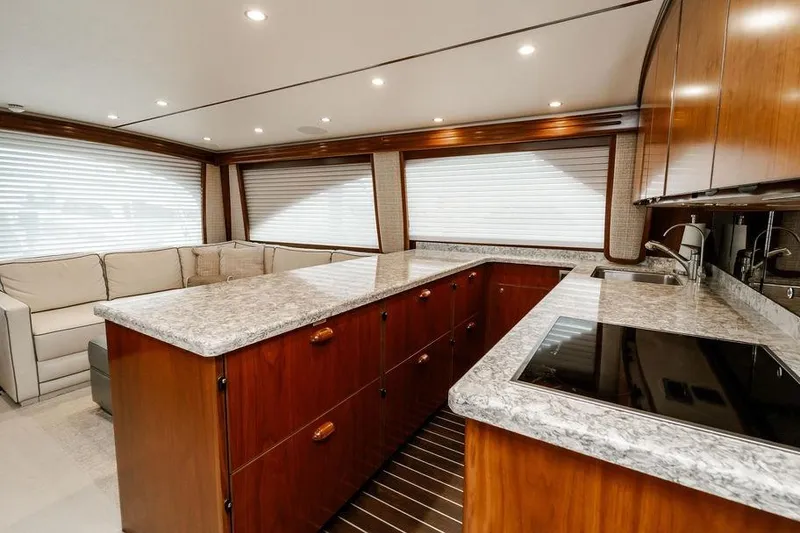 Slide: The Image of Luxurious interior of 2021 Viking 58 Convertible yacht with modern kitchen and seating area. - 120