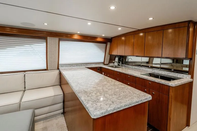 Slide: The Image of Luxurious interior of 2021 Viking 58 Convertible yacht with modern kitchen and seating area. - 125