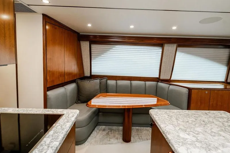Slide: The Image of Luxurious interior of 2021 Viking 58 Convertible yacht with elegant seating and dining area. - 126