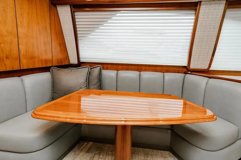 Slide: The Image of Luxurious interior of 2021 Viking 58 Convertible yacht with elegant wood table and plush seating. - 127