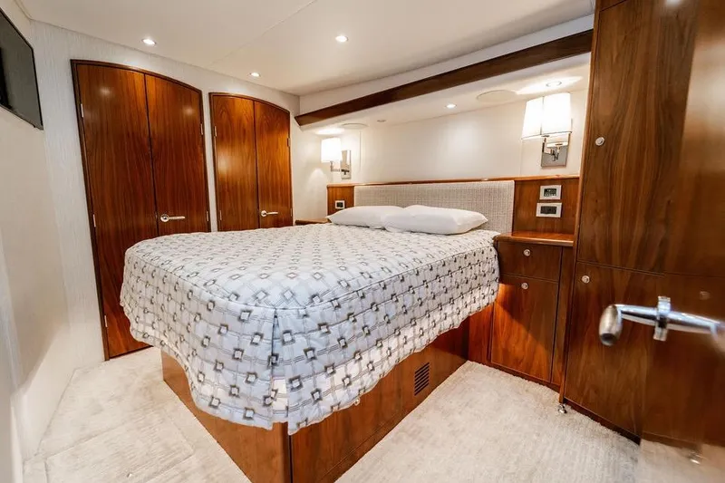 Slide: The Image of Luxurious cabin interior of 2021 Viking 58 Convertible yacht with elegant wood finish. - 13