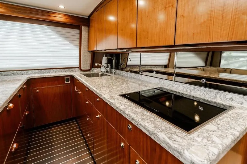 Slide: The Image of Luxurious kitchen interior of 2021 Viking 58 Convertible yacht with sleek countertops and modern appliances. - 130
