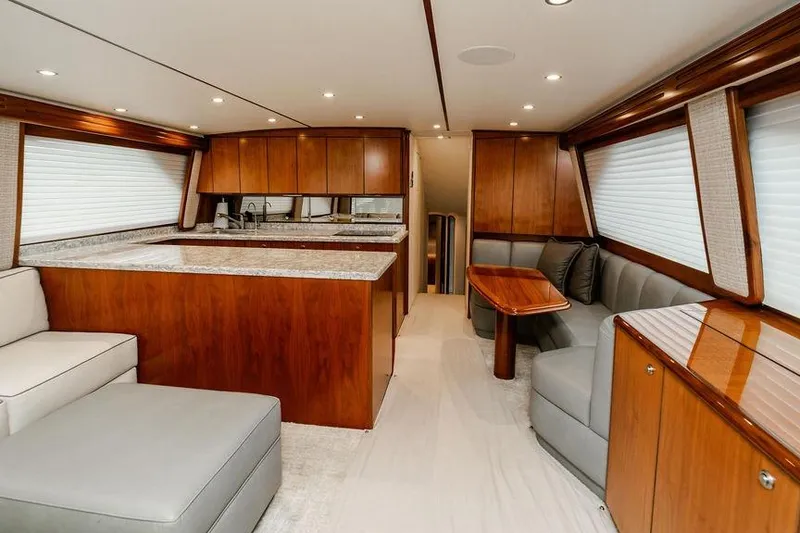 Slide: The Image of Luxurious interior of 2021 Viking 58 Convertible yacht with modern kitchen and seating area. - 132