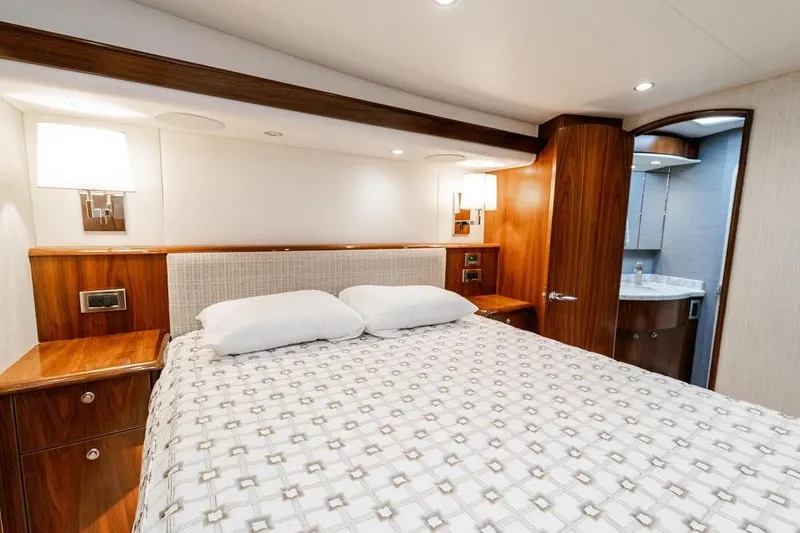 Slide: The Image of Luxurious bedroom interior of 2021 Viking 58 Convertible yacht with elegant wood finishes. - 14