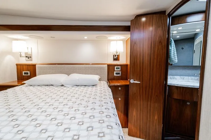 Slide: The Image of Luxurious bedroom interior of 2021 Viking 58 Convertible yacht with elegant wood finishes. - 15