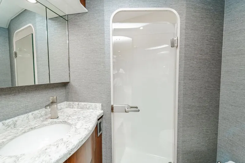 Slide: The Image of Luxurious bathroom in 2021 Viking 58 Convertible yacht with marble countertop and modern shower. - 16