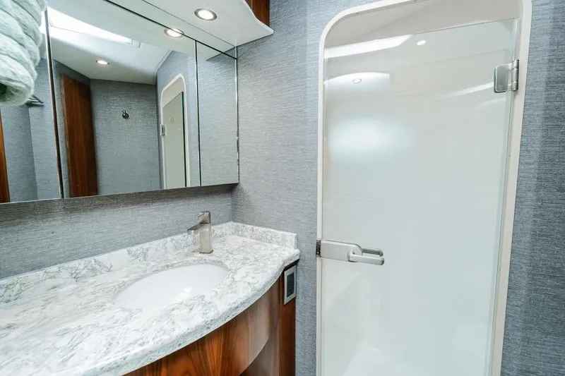 Slide: The Image of Luxurious bathroom in 2021 Viking 58 Convertible yacht with marble countertop and modern fixtures. - 17