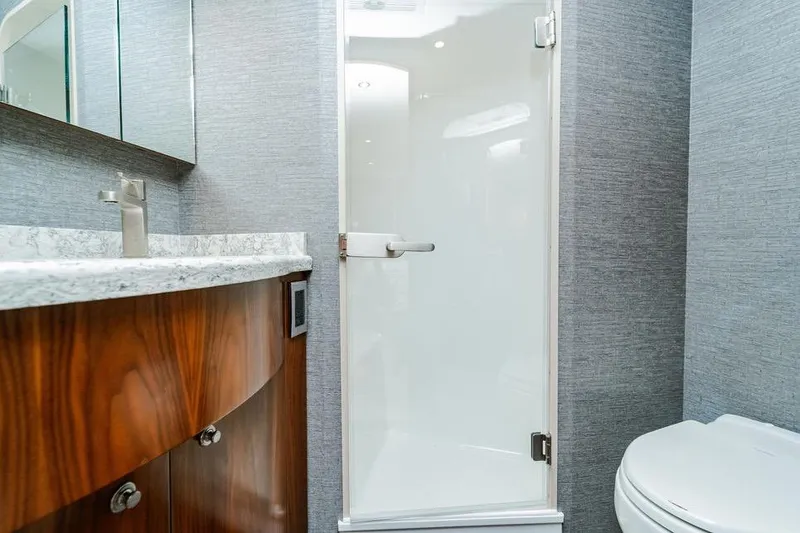 Slide: The Image of Luxurious bathroom in 2021 Viking 58 Convertible yacht with modern fixtures and elegant design. - 19