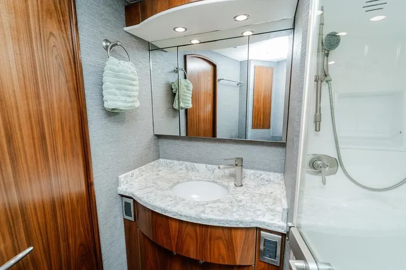 Slide: The Image of Luxurious bathroom in 2021 Viking 58 Convertible yacht with marble countertop and modern fixtures. - 23
