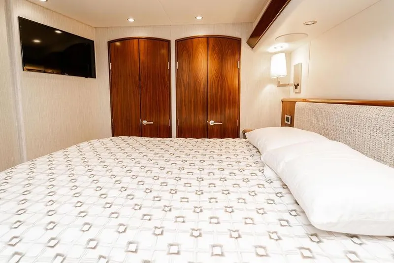 Slide: The Image of Luxurious bedroom interior of 2021 Viking 58 Convertible yacht with elegant wood doors. - 24