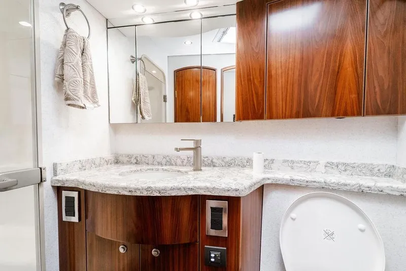 Slide: The Image of Luxurious bathroom in 2021 Viking 58 Convertible yacht with elegant wood cabinetry. - 26