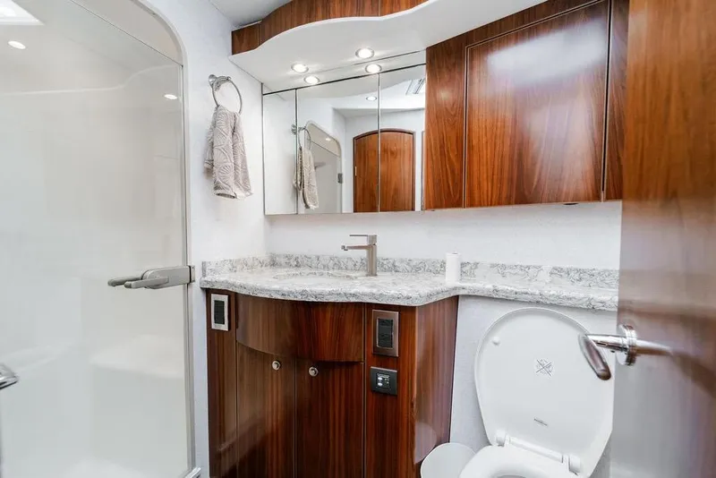 Slide: The Image of Luxurious bathroom in 2021 Viking 58 Convertible yacht with elegant wood cabinetry and modern fixtures. - 27